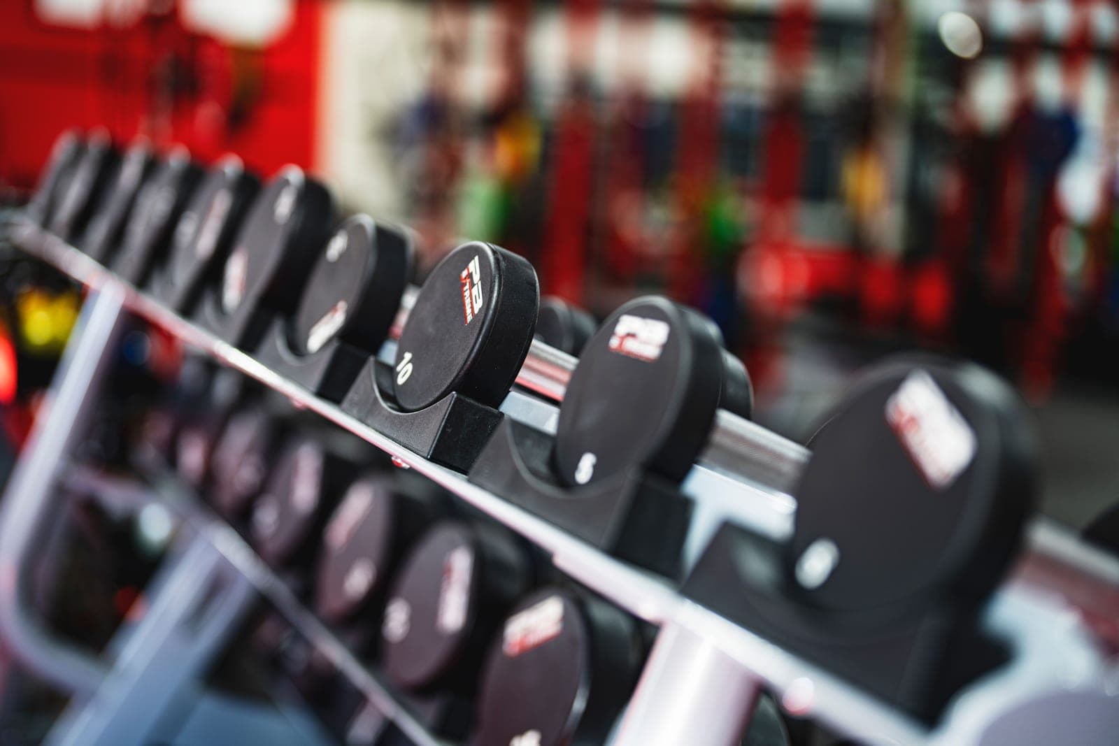 A budget home gym with a rack and dumbbells